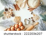 Bakery background with ingredients for cooking Christmas baking. Flour, eggs, cinnamon and gingerbread on the table top view.