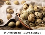 Small photo of Quail eggs on brown texture table background. Whole and broken quail eggs. natural products. Place for text. Fresh quail eggs.