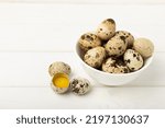 Small photo of Quail eggs in a bowl on a white texture background. Whole and broken quail eggs. Natural products. Place for text. Fresh quail eggs.