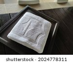Small photo of White furbish towel folded and waiting to be use