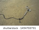 Small Anchor In Beach Sand For...