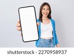 Small photo of Beautiful Asian woman holding smartphone mockup of blank screen and smiling on white background.