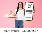 Studio shot of Beautiful Asian woman holding pizza boxes and smartphone with scan barcode for discount code coupon on pink background.