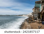 Small photo of Effects of climate change on the coast of the Pacific Ocean, houses on the verge of collapse due to sea level rise, rock barrier. Barra de Navidad, Cihuatlan, Jalisco, Mexico: 2 February 2024.
