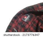 Small photo of Sidoarjo, Indonesia - June 27, 2022: a red plaid flannel shirt labeled with the brand QUICKSILVER