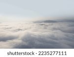 sunny foggy clouds in winter with small mountain view in winter season for create nature content. drone high view for content editing.