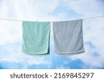 Towels drying under blue sky outdoors