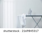 White shirt and iron on ironing board