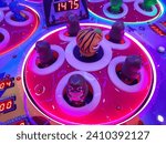 Small photo of Close up view of modern game of whack a moles in an arcade. Game concept. Technology, recreation. Carnival, festival, celebration. Neon light. Java, Indonesia - December 25, 2023