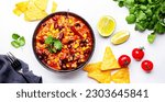Small photo of Chili con carne with minced beef, red beans, paprika, sweet corn and hot peppers in spicy tomato sauce, tex-mex cuisine dish, white table background, top view