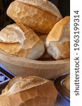 Small photo of Basket of French bread, traditional Brazilian bread, present at tables and meals throughout the country . On white tablecloth.