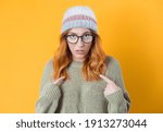Small photo of Guilty or guiltless confused young woman, isolated on yellow background. Studio shot