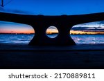 Small photo of Abstract minimal isolated boat cleat on dock with sunset background. Maritime boating cleat on boat dock with ocean background. Abstract minimal industrial dockyard.