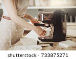 Woman making fresh espresso in coffee maker. coffee machine makes coffee. Barista Coffee Maker Machine Grinder Portafilter Concept