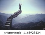 Businessman looking into the distance on abstract stairs. Landscape background. Research and vision concept 