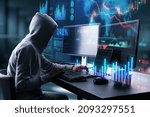 Hacker in hoodie using computers at desktop with glowing forex chart trading interface on blurry background. Market, hacking, malware, data theft, economy and data exchange concept. Double exposure