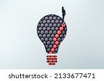 Businesswoman standing on abstract pattern light bulb on light background with mock up place. Idea, growth and success concept