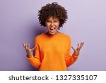 Small photo of Angry annoyed female gestures with annoyance, screams loudly, expresses irritation, wears casual orange jumper, reproaches partner in betrayal, isolated over purple studio wall. Stop it please