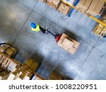 Male warehouse worker pulling a ...