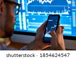 Business man trader investor analyst using mobile phone app analytics for cryptocurrency financial stock market analysis analyze graph trading data index investment growth chart on smartphone screen.
