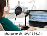 Small photo of technology, mass media and people concept - close up of woman with microphone and laptop computer talking and recording podcast at studio