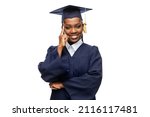 Small photo of education, graduation and people concept - happy graduate student woman in mortarboard and bachelor gown over white background