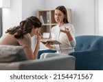 Small photo of psychology, mental health and people concept - psychologist with notebook talking to stressed woman patient at psychotherapy session