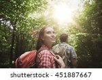 adventure, travel, tourism, hike and people concept - group of smiling friends walking with backpacks in woods
