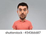emotion, facial expressions and people concept - surprised man in polo shirt over gray background (funny cartoon style character with big head)