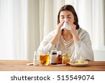 health care, flu, hygiene, age and people concept - sick woman with medicine blowing nose to paper wipe at home
