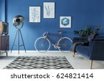 Black and white patterned carpet in trendy blue living room