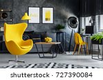 Designer's yellow chair next to ...