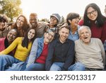 Group of multigenerational people smiling in front of camera - Multiracial friends of different ages having fun together - Main focus on caucasian senior faces