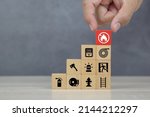 Small photo of Hand choose wooden block stack with fire prevent icon and door exit sing or fire escape with fire extinguisher and emergency protection symbol for safety and rescue in the building.