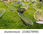 Small photo of cain chairs in green grass lawn background