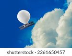 stratospheric balloon, complete with solar panels and cameras, travels at an altitude well above commercial air traffic in a blue sky