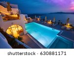 Swimming pool on the hotel terrace of fira's town, Greece. Incredibly romantic sunset on Santorini. Oia village in the morning light. Amazing sunset view with white houses. Island lovers