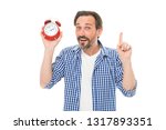 Small photo of Keeping track of time. Mature timekeeper with analog clock pointing finger up. Mature man holding alarm clock. Bearded senior man with mechanical clock in hand. Timekeeping and time measurement.