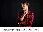 Small photo of Handsome well groomed man in checkered shirt. Manliness concept. Meaning of modern manliness. Male beauty, Barbershop and beauty salon. Hipster black background. Standards of manliness or masculinity.