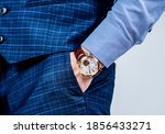 Essential accessory in any menswear collection. Luxury watch worn on male wrist. Classic timepiece. Fashion accessory. Trendy style. Punctuality and promptness. Current time.