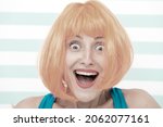 Small photo of happy crazy girl with omg or wow facial expression. happy girl with crazy look. wow. surprised happy girl with orange hair. crazy look of girl saying omg. what a surprise. feeling and emotions