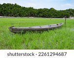 image of rowboat at riverside. rowboat at riverside nature. wooden rowboat at riverside