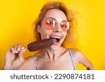 woman eating icecream isolated on yellow. woman with icecream in studio. woman with icecream