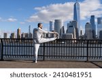 Small photo of Athlete stretching muscles and preparing for workout. Stretching routine of athlete outdoor. Gentle stretch. Athlete stretching his muscles after running. Athlete stretching to improve flexibility