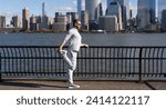 Small photo of Athlete stretching his muscles after running. Athlete stretching to improve flexibility. Athlete stretching muscles preparing for workout. Stretching routine of athlete outdoor. Stretch routine