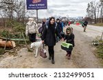 Small photo of IRPIN, UKRAINE - Mar. 05, 2022: War in Ukraine. Women, old people and children evacuated from Irpin town was transferd to Kyiv by Kyiv territorial defense battalion. War refugees in Ukrain