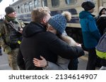 Small photo of KYIV, UKRAINE - Mar. 11, 2022: War refugees in Ukraine. People at Kyiv railway station are evacuated to the western safer areas of the country. Young couple hugging goodbye before boarding the train