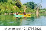 Small photo of 4000 ISLAND, LAOS - January 21, 2024. A group of tourists kayaking in the Mekong River.