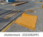 Small photo of Sidewalk ramp, manhole, road markings