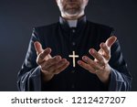 Small photo of Priest open hands arms praying offering oblation